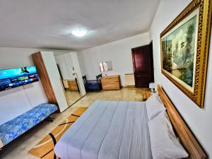 a room with a bed and a painting on the wall at House Riky in Assemini