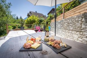 a tray of food and two glasses of wine on a table at Le Chalet des 3 Monts in Les Clefs