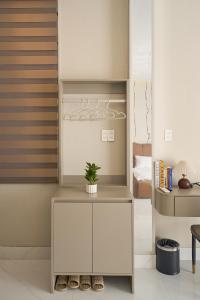 a room with a white cabinet with a plant on it at Minh Nhat Villa - 3S Villa in Cồn Giả Viên