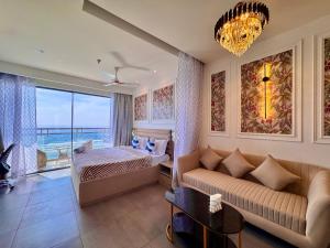 a living room with a couch and a bed at Mulberry Homes Supernova in Noida