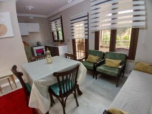 a kitchen and dining room with a table and chairs at Vinland Villa Atalar in Trabzon