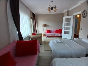 a hotel room with two beds and a couch at Vinland Villa Atalar in Trabzon