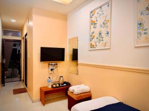 a hotel room with a bed and a tv on the wall at Hotel Shree Darshan - Near Mahakal Mandir Ujjain in Ujjain +21 photos