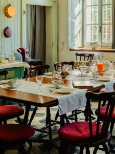 a table with plates and wine glasses on it at Villa Galimberti Maison De Charme in Osnago