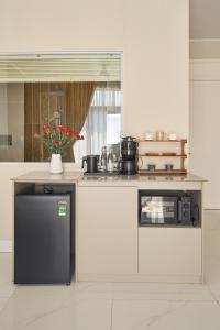 a kitchen with a counter with a stove and a sink at Minh Nhat Villa - 3S Villa in Cồn Giả Viên +24 photos