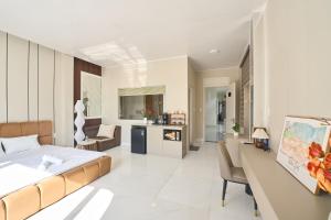 a bedroom with a bed and a living room at Minh Nhat Villa - 3S Villa in Cồn Giả Viên