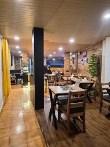 a restaurant with tables and chairs in a room at Ratnagiri Boutique Hotel in Mirik