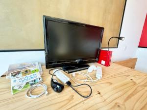 a flat screen tv sitting on top of a wooden table at Chez Mamie Cloclo in Calais