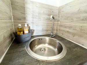 a kitchen sink with a faucet on top of it at Chez Mamie Cloclo in Calais +23 photos