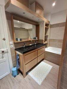 a bathroom with a sink and a bath tub at La maison de Lau in Salies-de-Béarn +20 photos