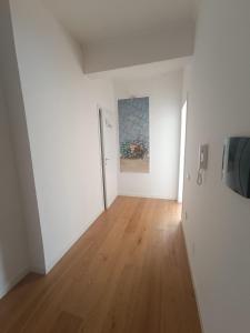 an empty room with white walls and a wooden floor at Suite Del Redentore 44 in Caserta