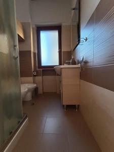 a bathroom with a sink and a toilet and a window at Suite Del Redentore 44 in Caserta