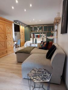 a living room with a couch and a bed at Le chalet de cathy in Soultzeren +29 photos