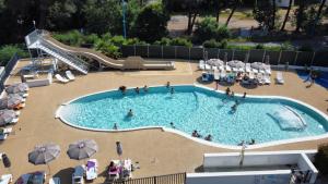 a swimming pool with people in a resort at Camping La Provençale - Maeva in Mandelieu-La Napoule +25 photos