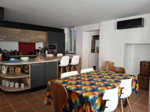 a kitchen and dining room with a table and chairs at La maison de Lau in Salies-de-Béarn