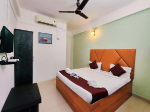 a bedroom with a large bed and a television at Samudrasneha Resort in Nagaon +36 photos