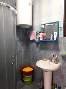 a small bathroom with a sink and a mirror at Vacation home in Virpazar +44 photos