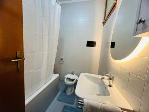 a white bathroom with a sink and a toilet at Suite Semeria 236 - Vista mare Sanremo in Sanremo +23 photos