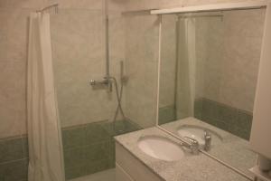 a bathroom with a sink and a shower at Cervinia Apartments in Breuil-Cervinia