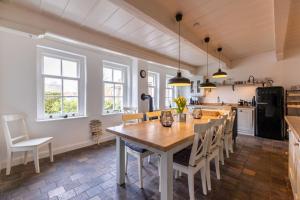 a kitchen with a large wooden table and chairs at K94 Fischerhaus in Greetsiel