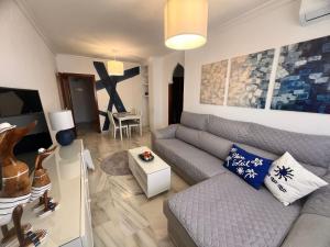 a living room with a couch and a table at Puertas del Mar 1 in Puerto Real