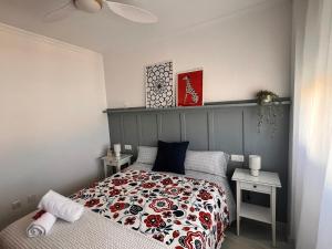 a small bedroom with a bed and two tables at Puertas del Mar 1 in Puerto Real