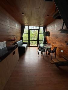 a living room with a couch and a table and chairs at Lostcabins in Vallikavungal