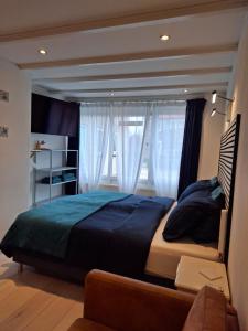 a bedroom with a large bed in front of a window at Dulce Tierra - vakantiewoning in Zoutelande