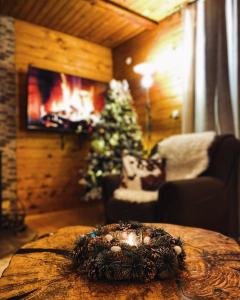 a living room with a christmas tree and a table at Mountain houses Milovanovic in Žabljak +51 photos