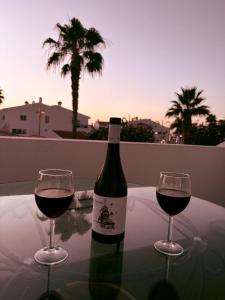 a bottle of wine and two glasses on a table at La Playa in Adeje