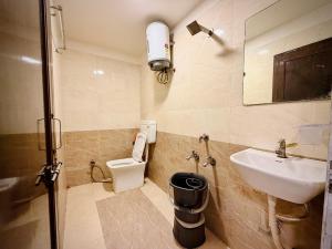 a bathroom with a sink and a toilet at Hotel Shree Darshan - Near Mahakal Mandir Ujjain in Ujjain