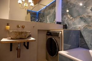 a bathroom with a sink and a washing machine at Hostel oder Ferienwohnung 1-16 Personen im BLAUEN HAUS in Fehmarn +69 photos