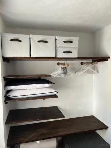 a walk in closet with shelves and white towels at Casa Vacanze Ginger in Grange Sises