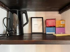 a coffee pot sitting on a shelf with boxes at Casa Vacanze Ginger in Grange Sises