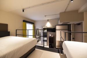 a room with two beds and a room with at Joy 124 Hotel Milano in Milan