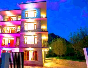a tall building with purple lights on it at Pinnacle view in Manāli