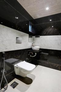 a bathroom with a toilet and a sink at Ramya Residency Navi Mumbai in Navi Mumbai