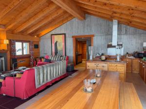 a living room with a red couch and a table at Chalet Sainfoin in Verbier