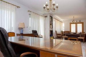 a living room with a table and a dining room at ENDLESS BLUE WAVE in Paleo Tsifliki +121 photos