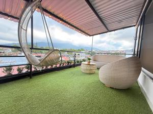 a room with a hammock on a balcony with a view at Toba hotel boutique in Ibagué