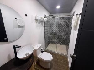 a bathroom with a toilet and a shower at Toba hotel boutique in Ibagué +41 photos