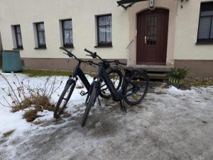 a bike parked in front of a house in the snow at Ferienwohnung Waldenburg Sachsen II in Waldenburg
