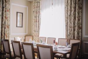 a dining room with a table and chairs and a window at Pazo Santa Teresa in Redondela