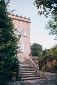 a brick building with stairs in front of it at Pazo Santa Teresa in Redondela