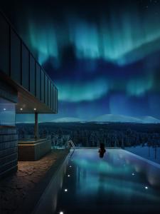 a house with a swimming pool under the northern lights at Arcora Boutique Hotel & Villas in Muonio