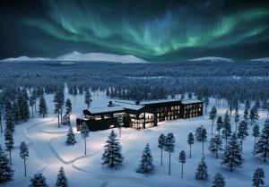 an aerial view of a lodge under the aurora at Arcora Boutique Hotel & Villas in Muonio