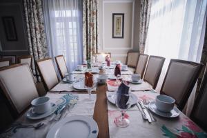a dining room with a long table with plates and silverware at Pazo Santa Teresa in Redondela