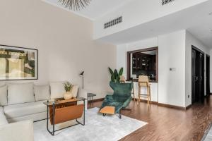 a living room with a couch and a table at GuestReady - 1BR | Private Garden - Burj Khalifa in Dubai