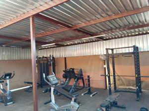 a gym with several exercise equipment in a building at Claypot Guesthouse in Northam +7 photos