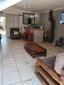 a living room with a table on a tiled floor at Claypot Guesthouse in Northam